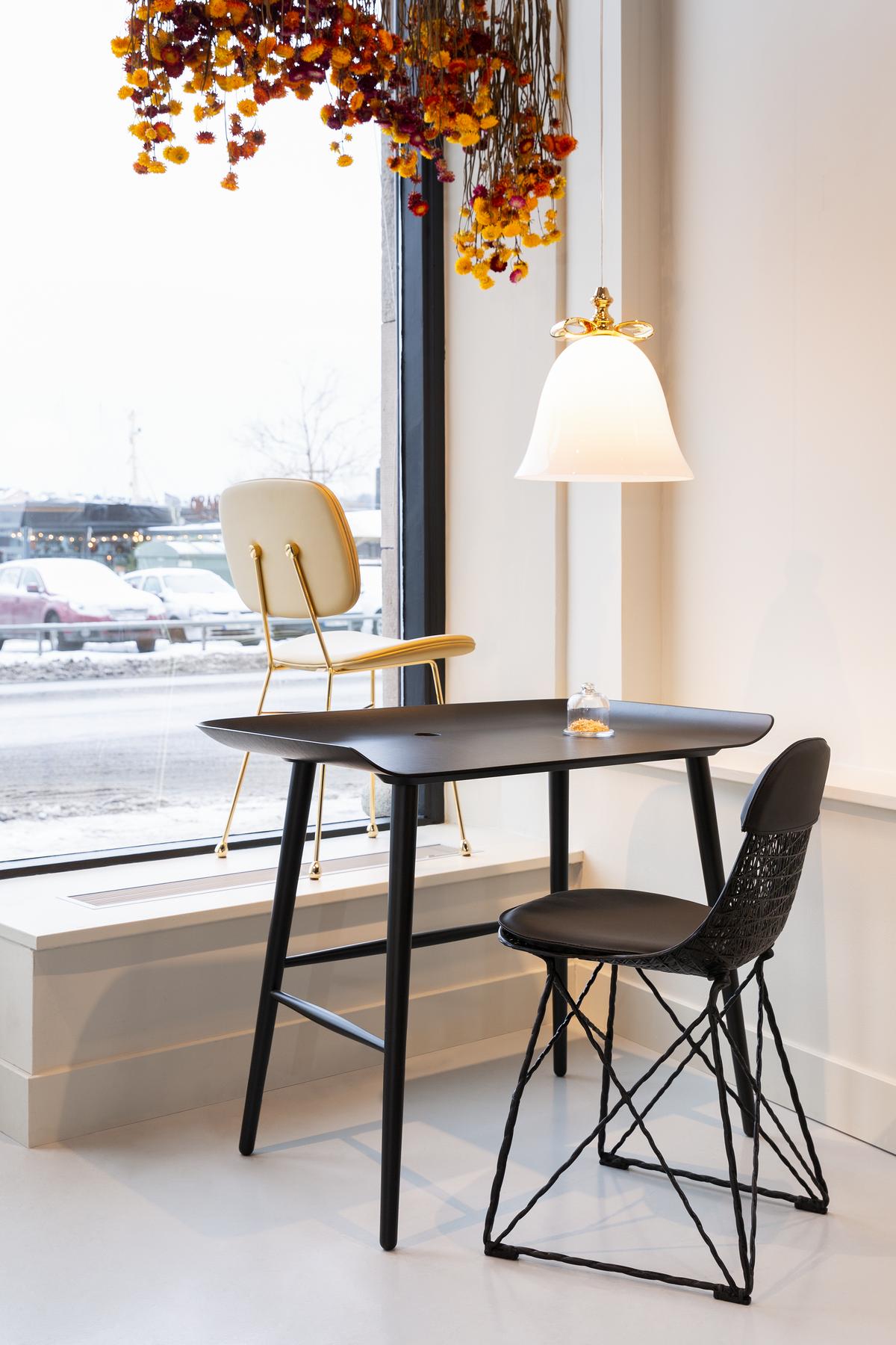 Interior of Stockholm Showroom with The Golden Chair, Woood desk and Bell Lamp suspension
